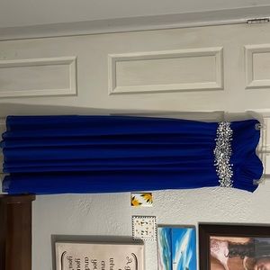 Blue long strapless dress, with crystal in the front. Only worn once.